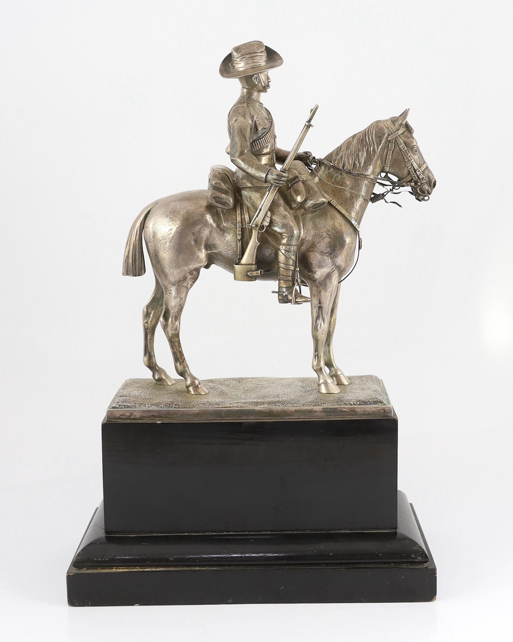 An early 20th century silver model of a City Imperial Volunteer, holding a rifle, on horseback, early 20th century